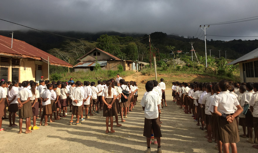 Children line up at school to learn about the (S)WASH-D for Worms research project in Timor-Leste