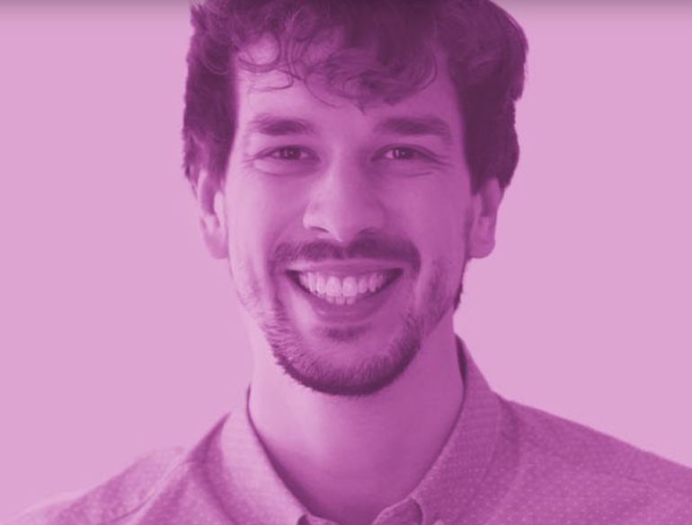 Smiling man in collared shirt with purple filter