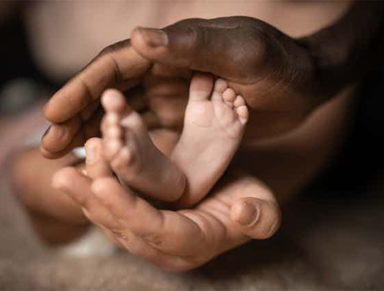 Hands holding baby feet credit shutterstock