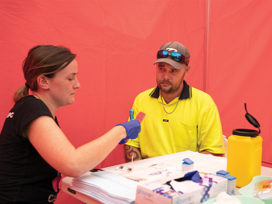 Research Associate Anna Conway with a client at a point-of-care testing service