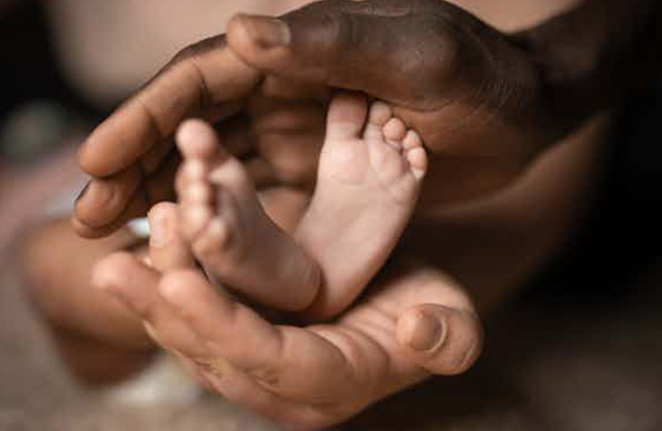 Hands holding baby feet credit shutterstock