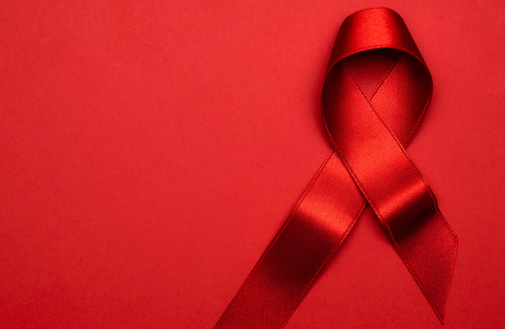 Red AIDS ribbon on red background